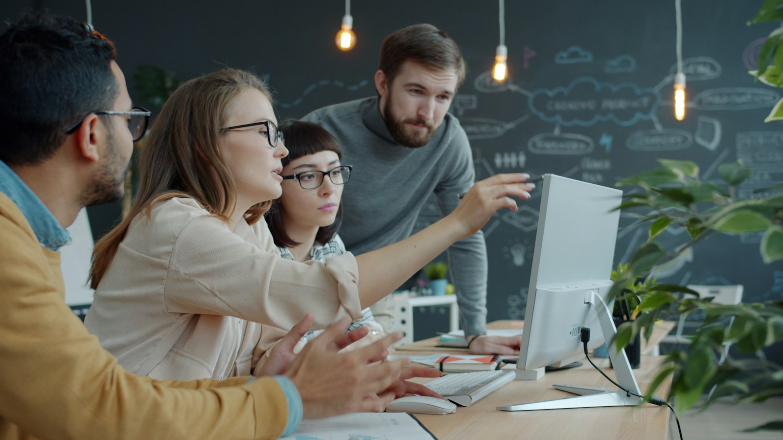 Digitalisierung der Unternehmensführung: Team arbeitet gemeinsam an einem Laptop im Büro
